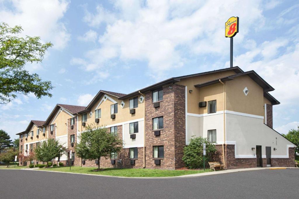 a building with a flag on top of it at Super 8 by Wyndham Canton/Livonia Area in Canton