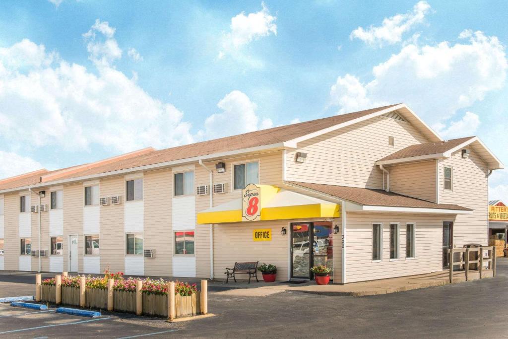 a fast food restaurant with a building at Super 8 by Wyndham Moberly MO in Moberly