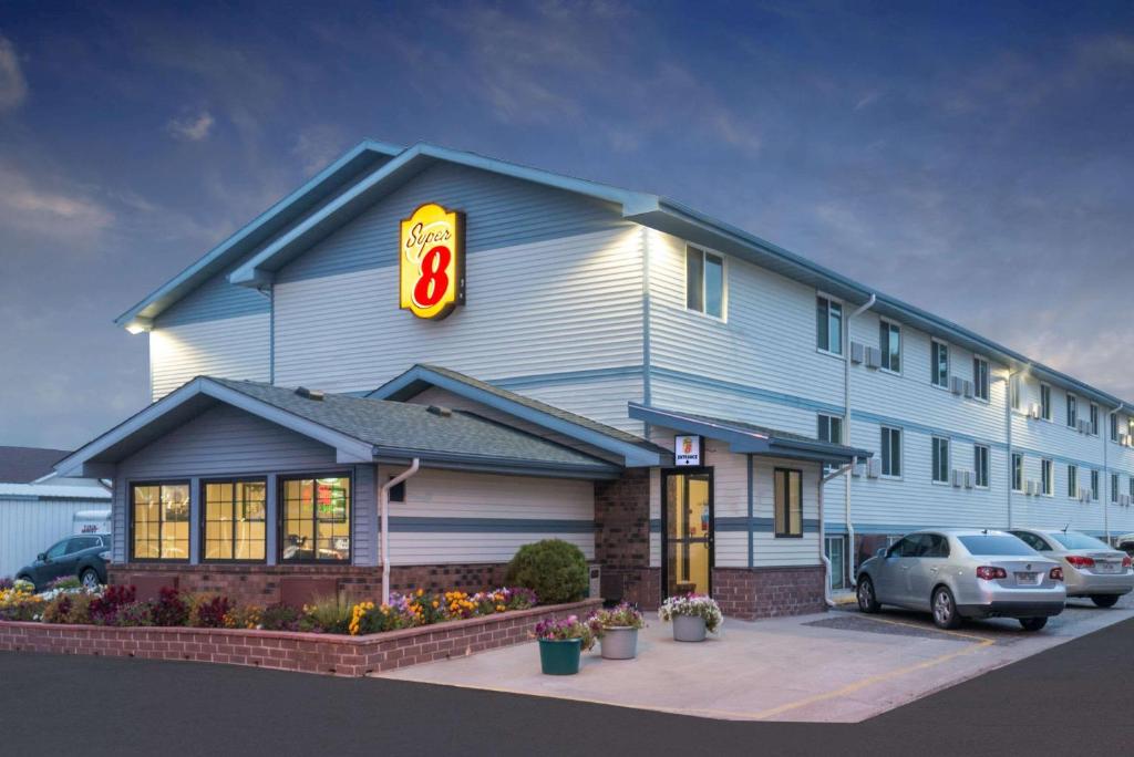 a fast food restaurant with a sign on the side of it at Super 8 by Wyndham Pierre SD in Pierre