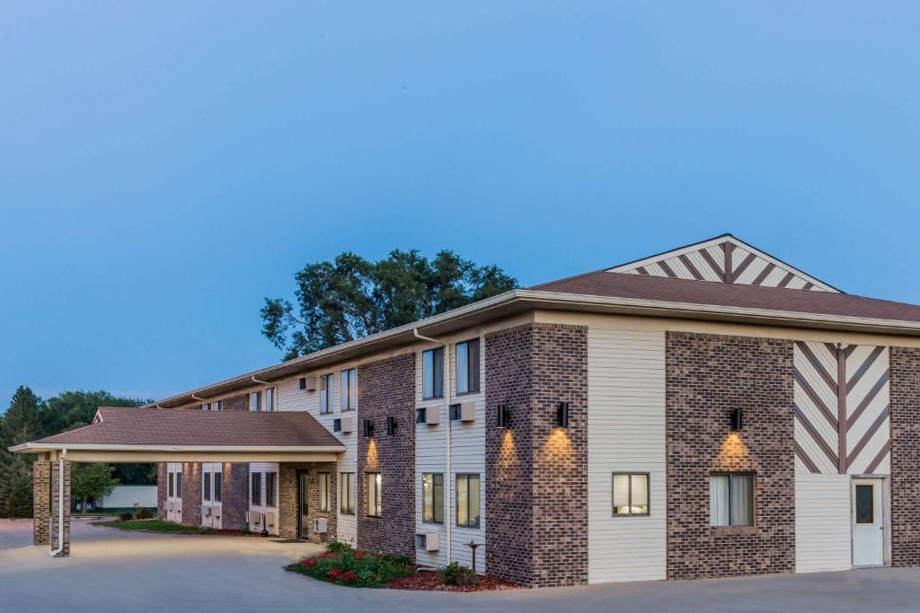 a rendering of a hotel building with a parking lot at Super 8 by Wyndham Madison in Madison