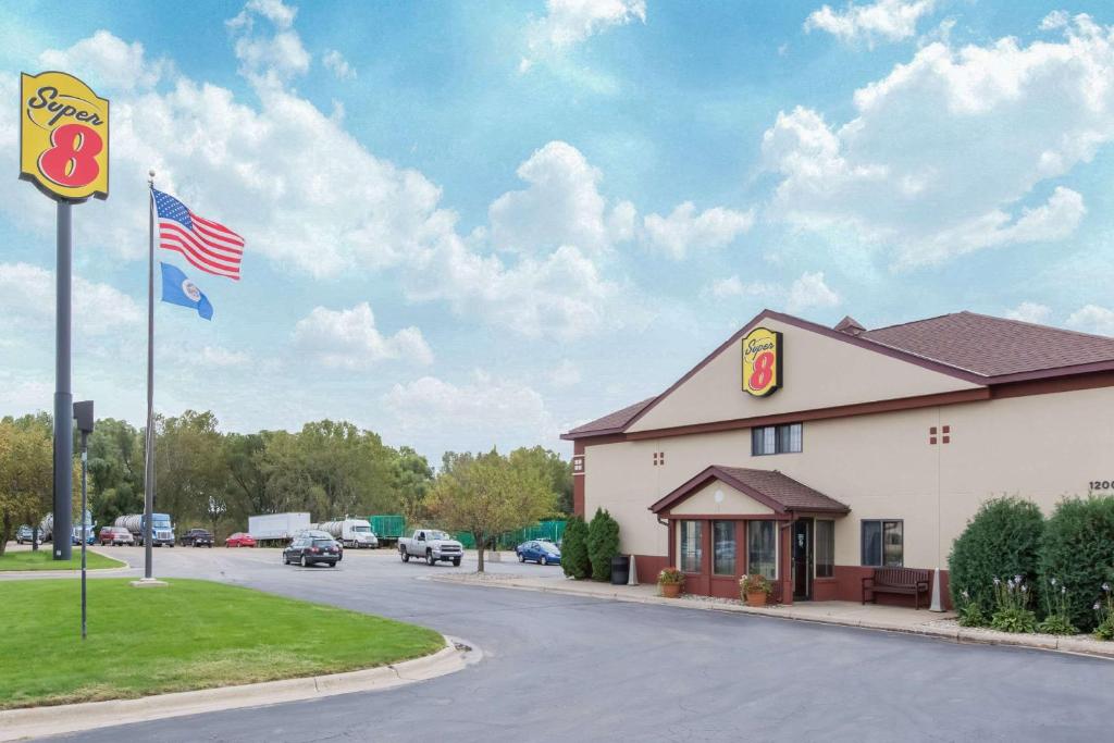 a mcdonalds restaurant with an american flag on a street at Super 8 by Wyndham Fairmont in Fairmont