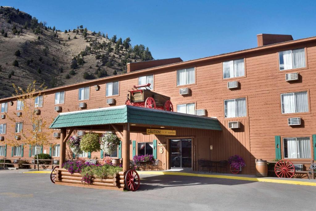 a large brown building with a building with a balcony at Super 8 by Wyndham Jackson Hole in Jackson