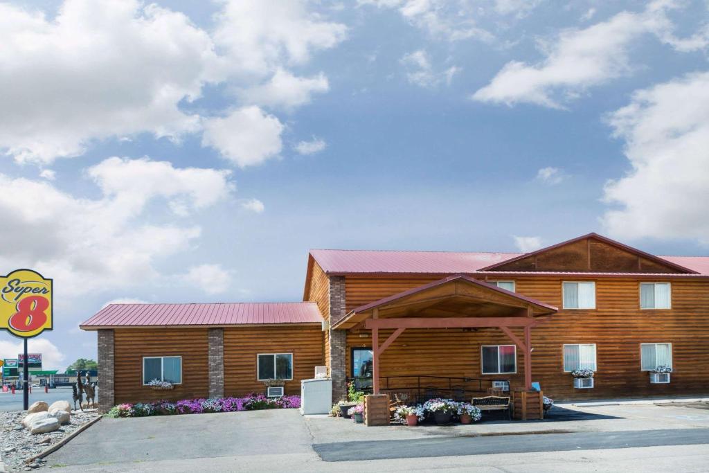 a large wooden building with a red roof at Super 8 by Wyndham Powell in Powell