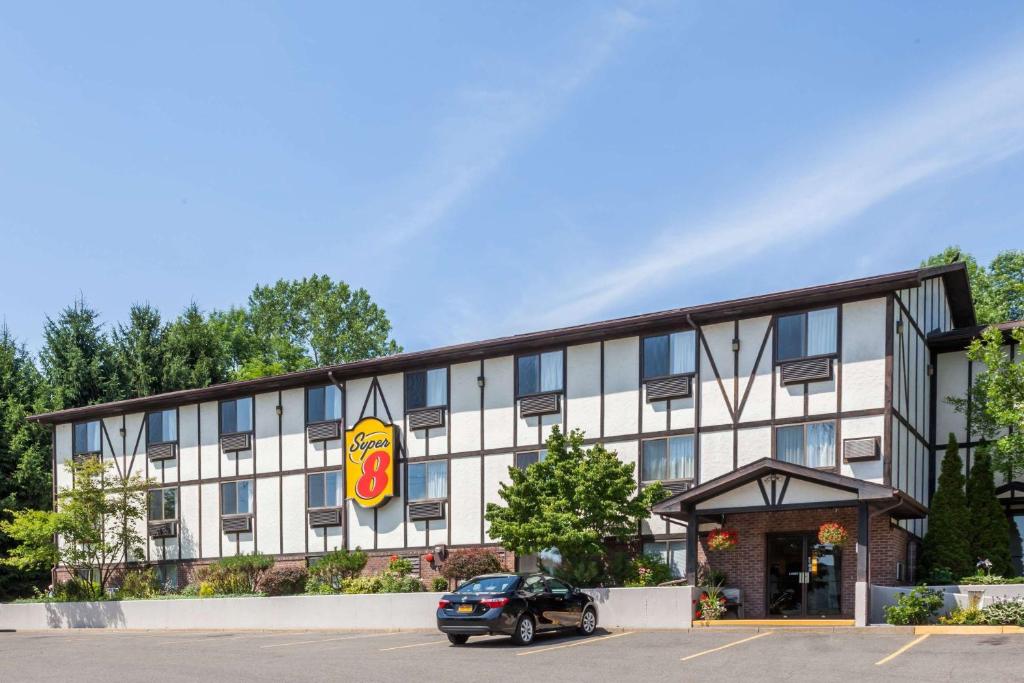 a hotel with a car parked in front of it at Super 8 by Wyndham Norwich in Norwich