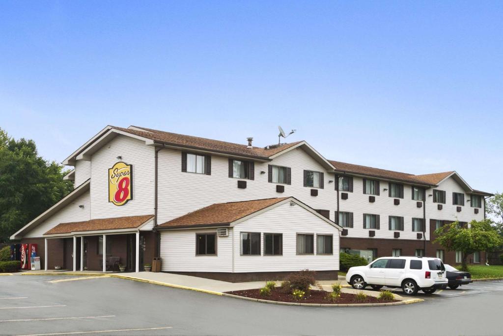 a hotel with a car parked in front of it at Super 8 by Wyndham New Castle in New Castle