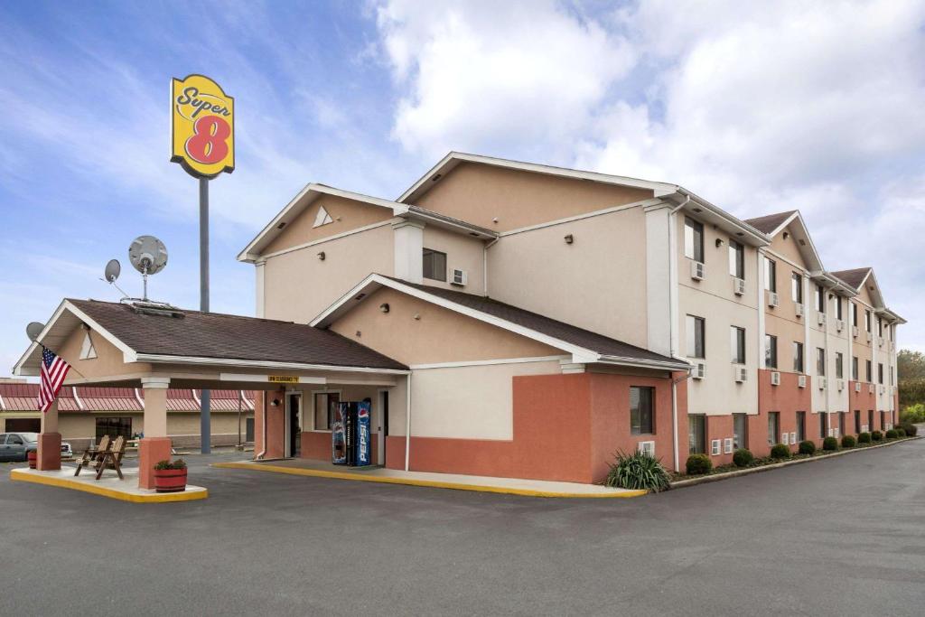 a mcdonalds restaurant with a sign in a parking lot at Super 8 by Wyndham Brookville in Brookville