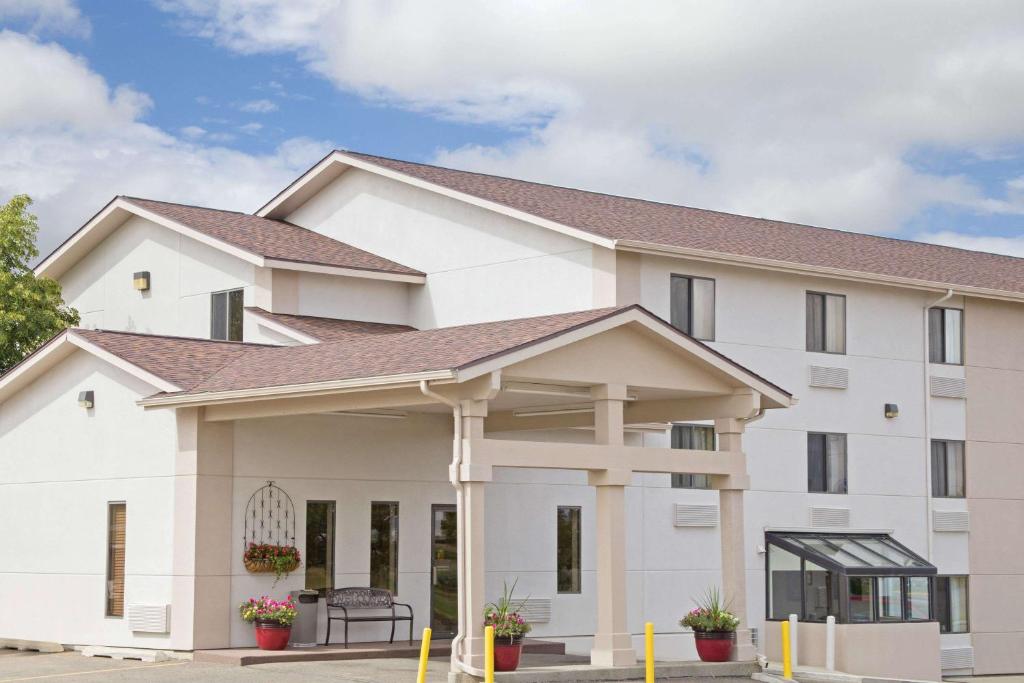 a large white building with a roof at Super 8 by Wyndham Havre in Havre