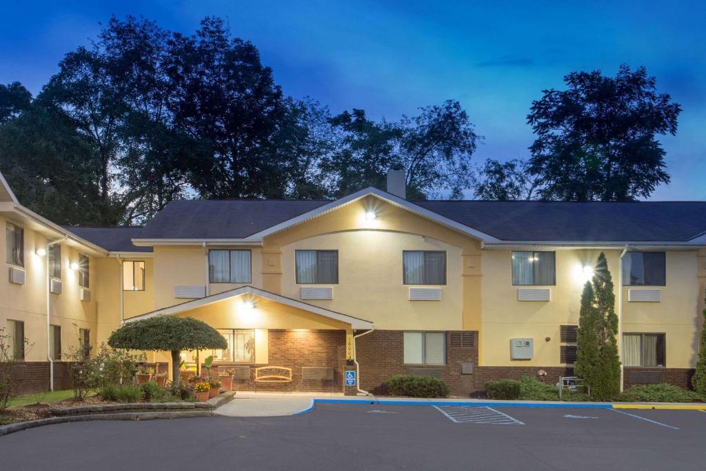 a large apartment building with a parking lot at Super 8 by Wyndham Radford VA in Radford