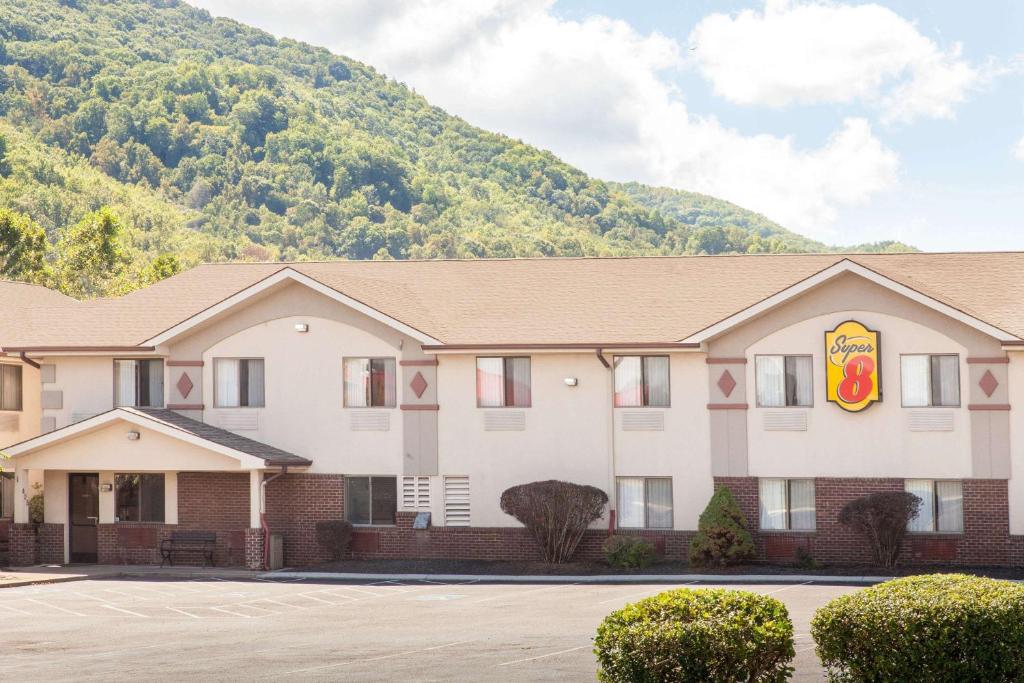 a hotel with a mountain in the background at Super 8 by Wyndham Norton VA in Norton