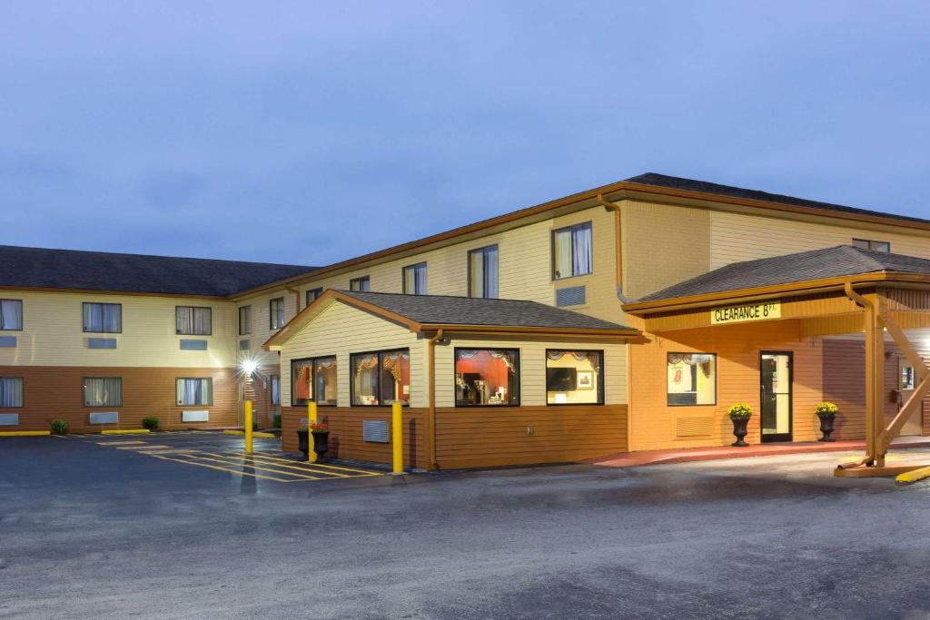 a hotel building with a parking lot in front of it at Super 8 by Wyndham Richmond in Richmond