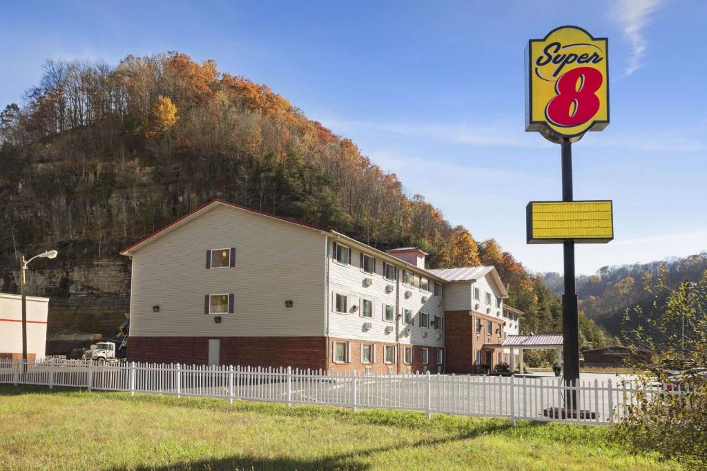 a sign for a super motel in front of a mountain at Super 8 by Wyndham Prestonsburg in Prestonsburg