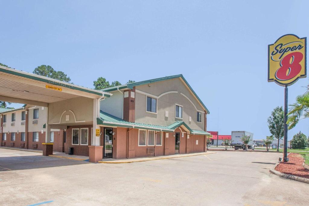 an empty parking lot in front of a motel at Super 8 by Wyndham Natchitoches in Natchitoches