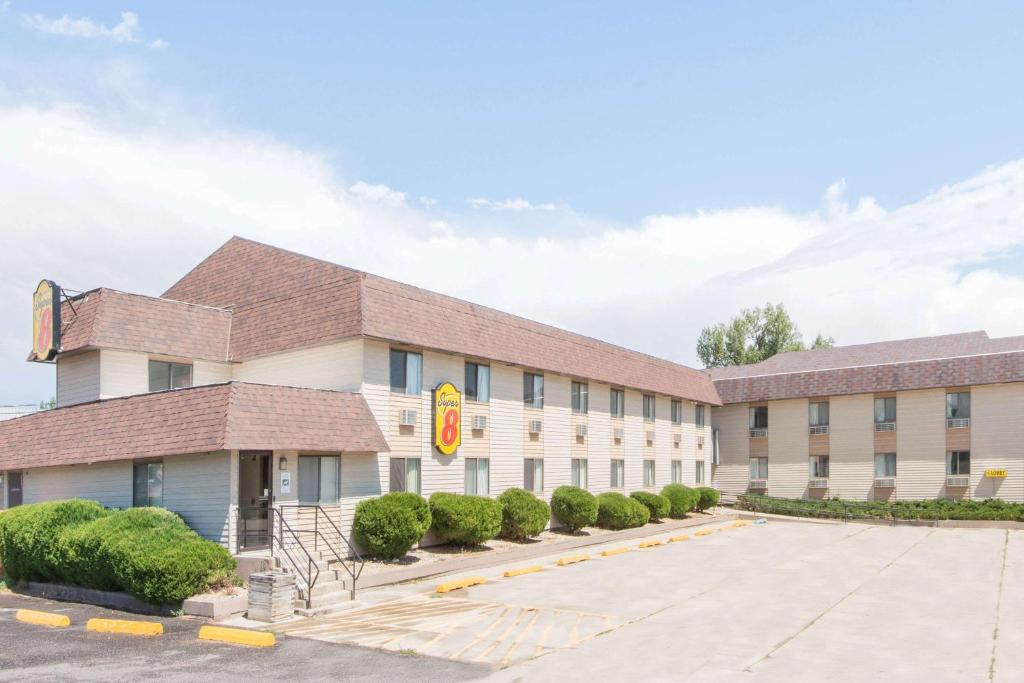 a building with a parking lot in front of it at Super 8 by Wyndham Buffalo in Buffalo