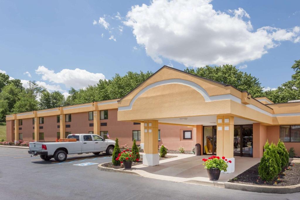 a building with a truck parked in front of it at Super 8 by Wyndham Logansport in Logansport