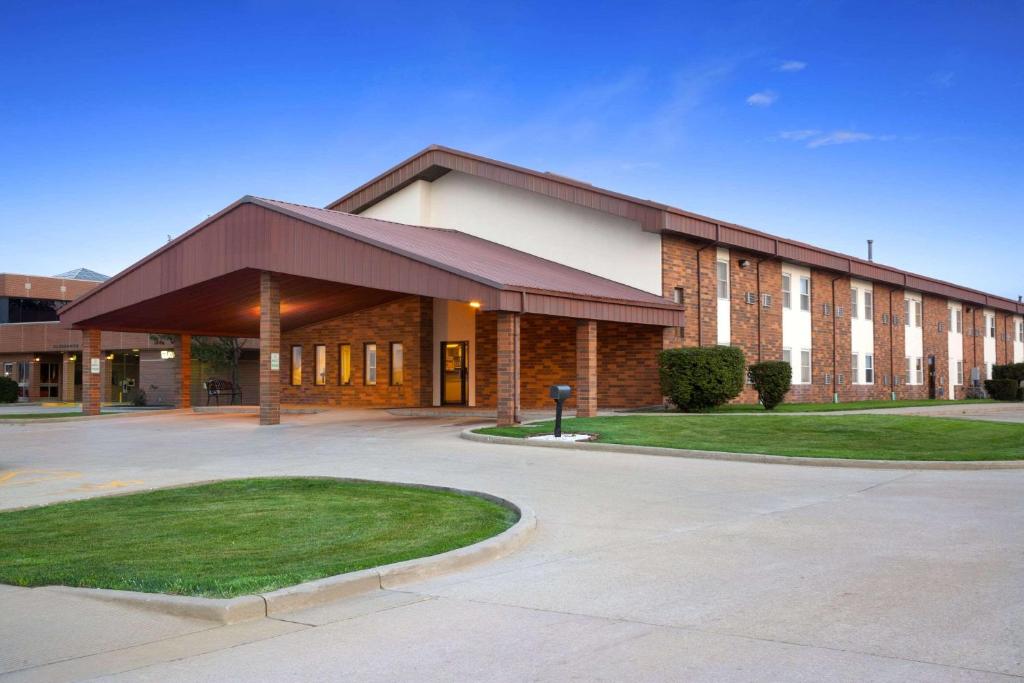 a large brick building with a driveway in front of it at Super 8 by Wyndham Tuscola in Tuscola