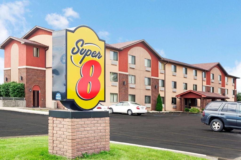 a sign for a super hotel in a parking lot at Super 8 by Wyndham Romeoville Bolingbrook in Romeoville