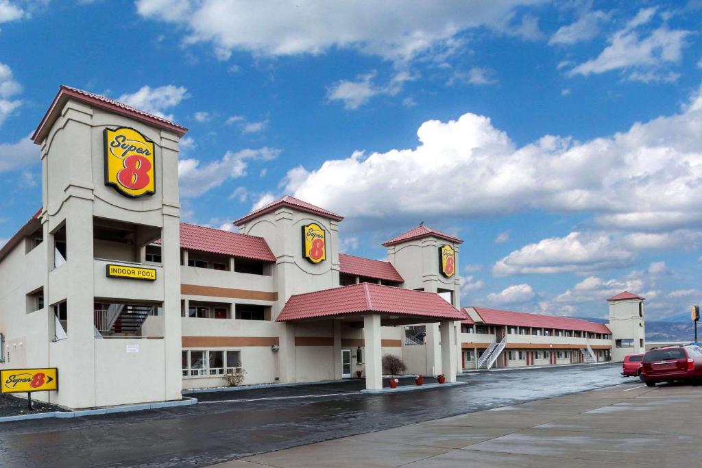 a fast food building with a car parked in a parking lot at Super 8 by Wyndham Fernley in Fernley