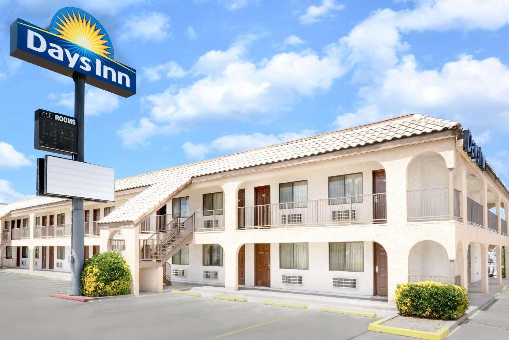 a building with a street sign in front of it at Days Inn by Wyndham Kingman East in Kingman