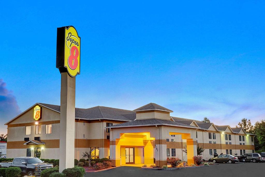 a fast food restaurant with a sign in a parking lot at Super 8 by Wyndham Hernando in Hernando