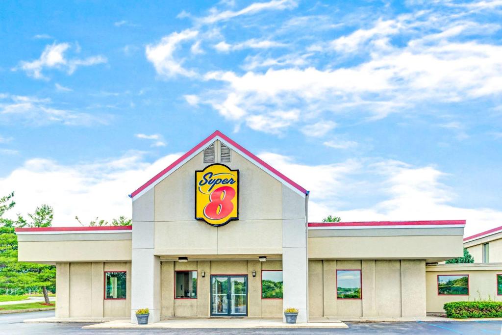 a fast food restaurant with a donut sign on it at Super 8 by Wyndham Indianapolis South in Indianapolis