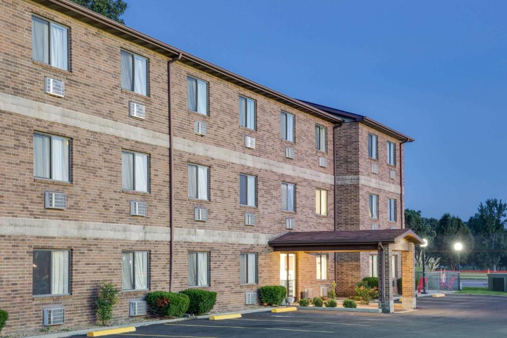 a large brick building with a parking lot at Super 8 by Wyndham Kennett in Kennett