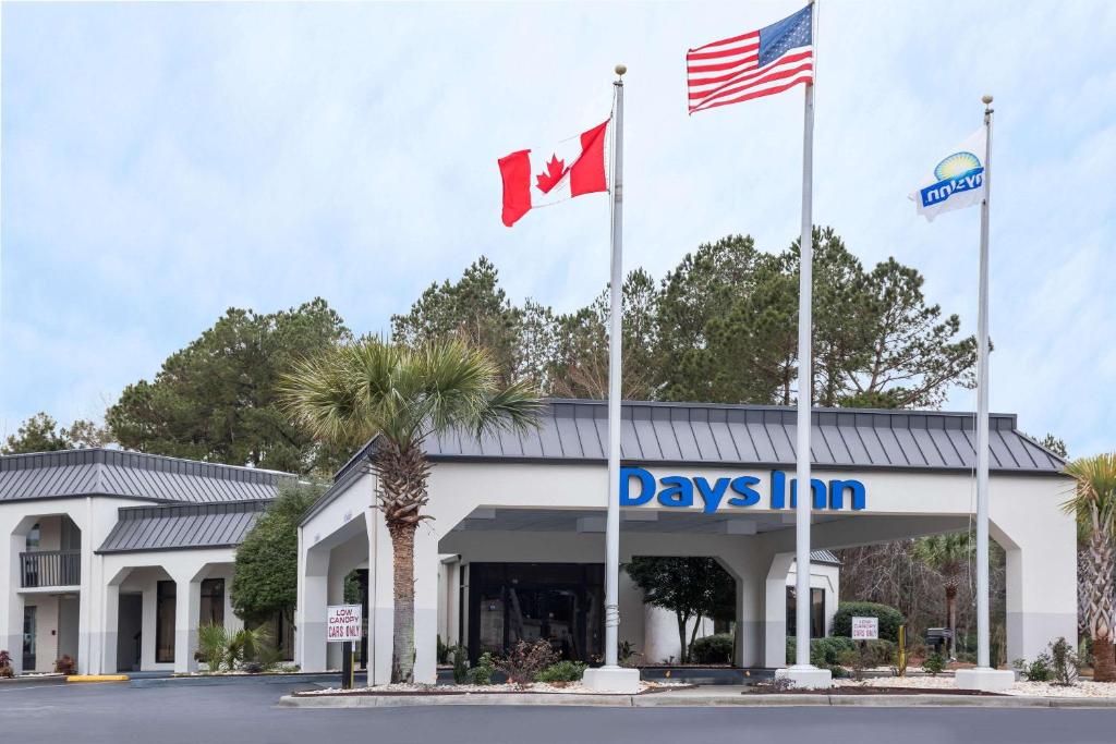 two flags flying in front of a day inn at Days Inn by Wyndham Walterboro in Walterboro
