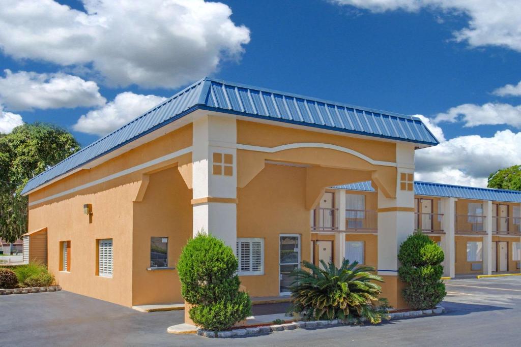 a large building with a blue roof at Super 8 by Wyndham Port Royal/Beaufort in Port Royal
