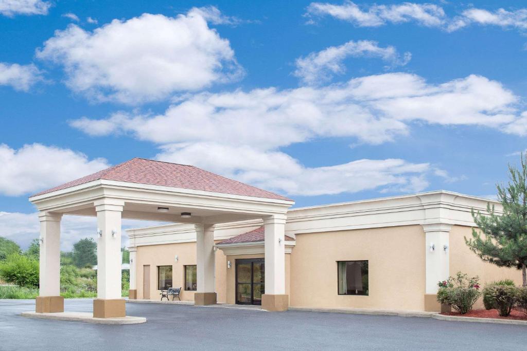 a large building with pillars and a blue sky at Super 8 by Wyndham Danville in Danville