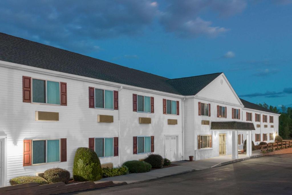 a large white building with red and green windows at Super 8 by Wyndham Webster/Rochester in Webster