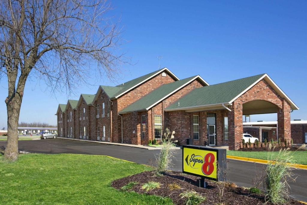 a large brick building with a sign in front of it at Super 8 by Wyndham Stafford/Springfield Area in Strafford