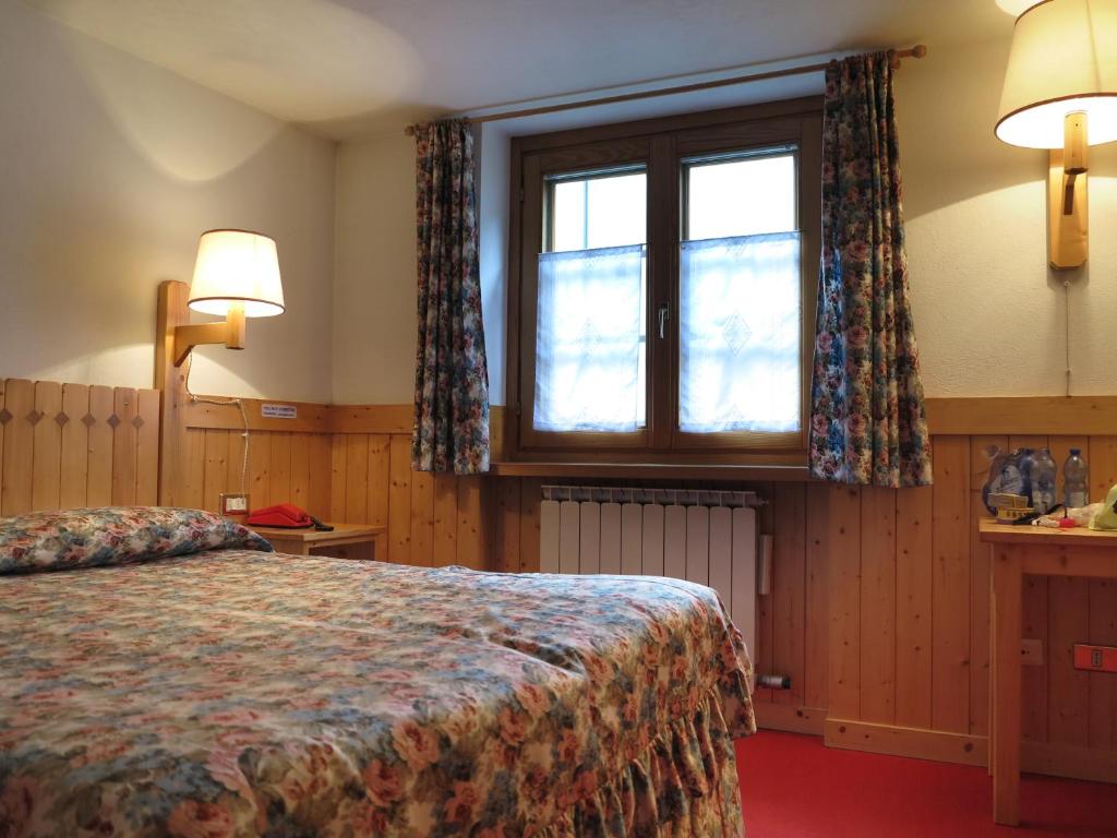 Postel nebo postele na pokoji v ubytování Hotel Locanda Grauson