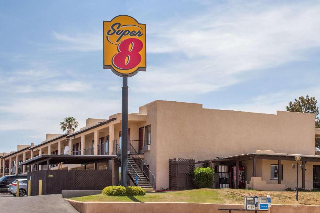 a super sign in front of a building at Super 8 by Wyndham Barstow in Barstow