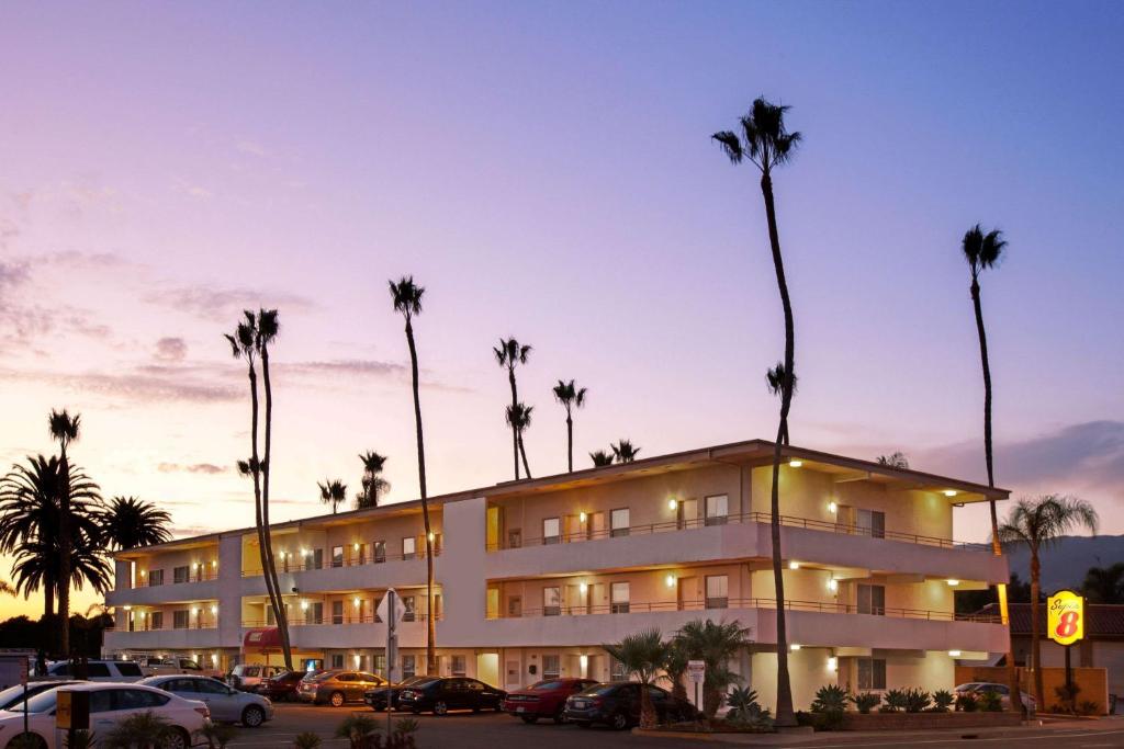 a hotel room with a large palm tree in front of it at Super 8 by Wyndham Santa Barbara/Goleta in Santa Barbara