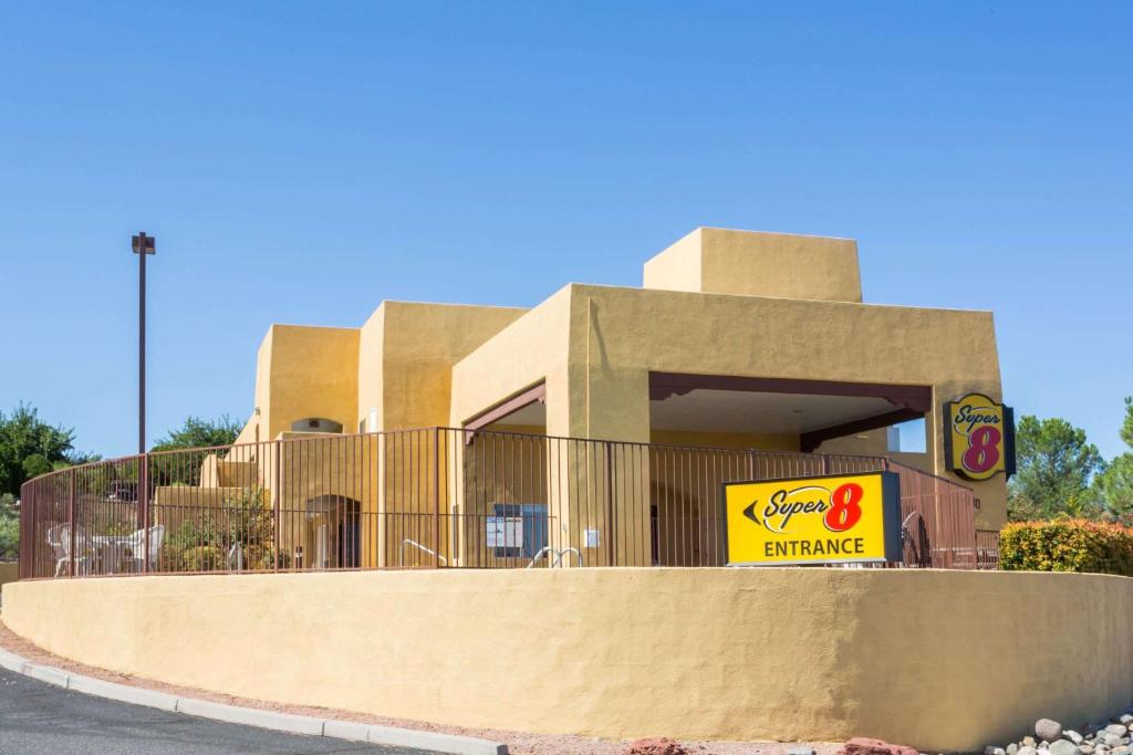 a building with a sign in front of it at Super 8 by Wyndham Cottonwood in Cottonwood