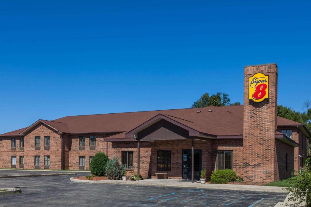 a large brick building with a sign on it at Super 8 by Wyndham Rochester in Rochester