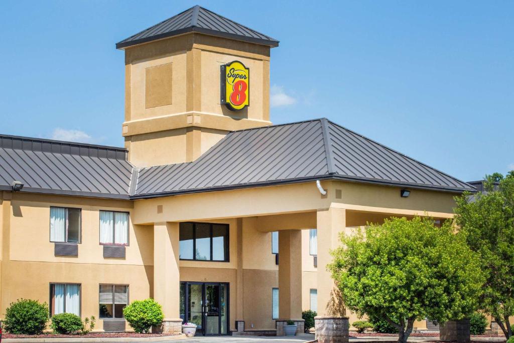 a building with a clock tower on top of it at Super 8 by Wyndham Piedmont Greenville Area in Piedmont