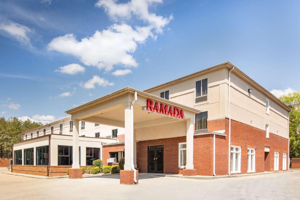 a building with a kmarma sign on the front of it at Ramada by Wyndham Alpharetta Atlanta North in Alpharetta