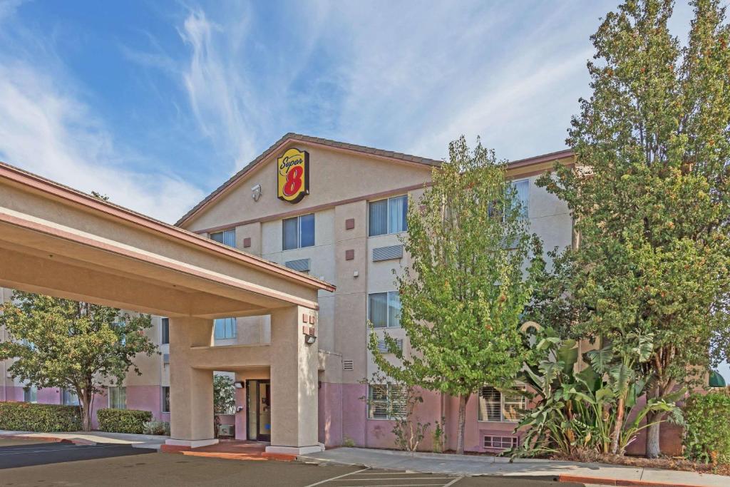 a hotel building with a krispy kreme at Super 8 by Wyndham Dixon/UC Davis in Dixon