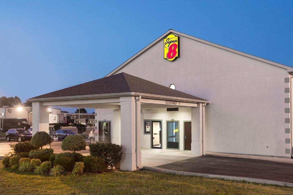 a fast food restaurant with a pdq sign on it at Super 8 by Wyndham Booneville in Booneville