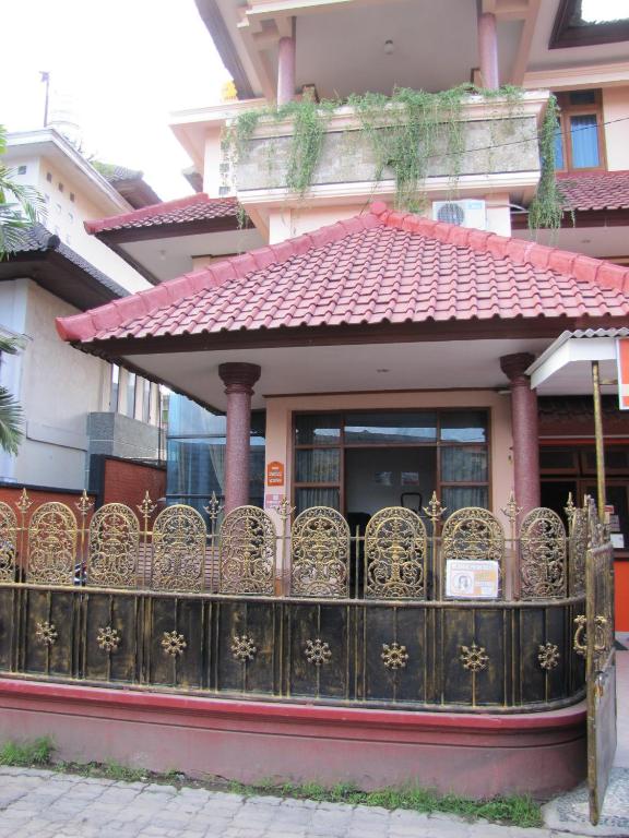 a gate in front of a building with a fence at Diva House in Denpasar