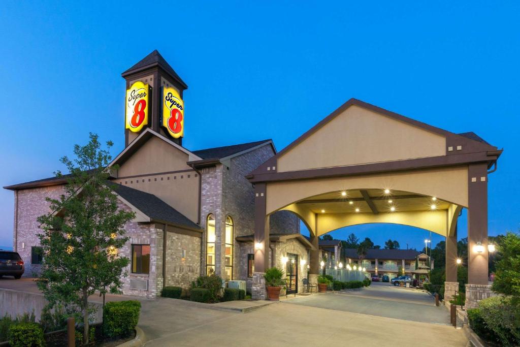 a hotel with an archway in front of a building at Super 8 by Wyndham Fairfield Tx in Fairfield