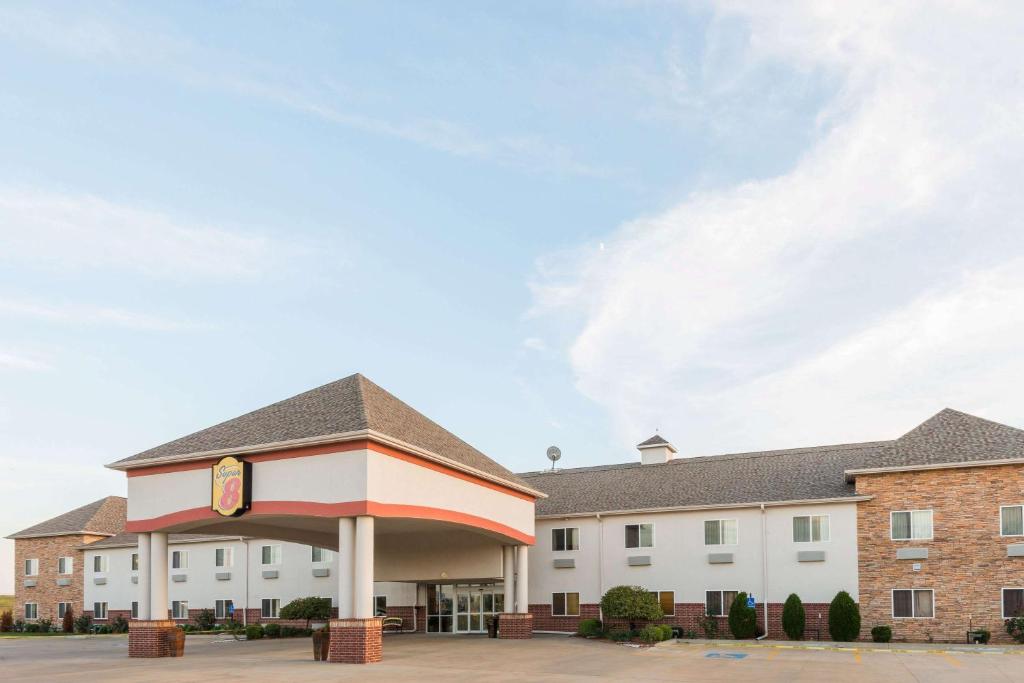 a building with a clock on the front of it at Super 8 by Wyndham Salina in Salina