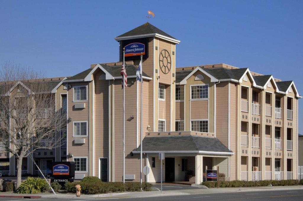 a large building with a clock tower in front of it at Howard Johnson by Wyndham Salinas in Salinas