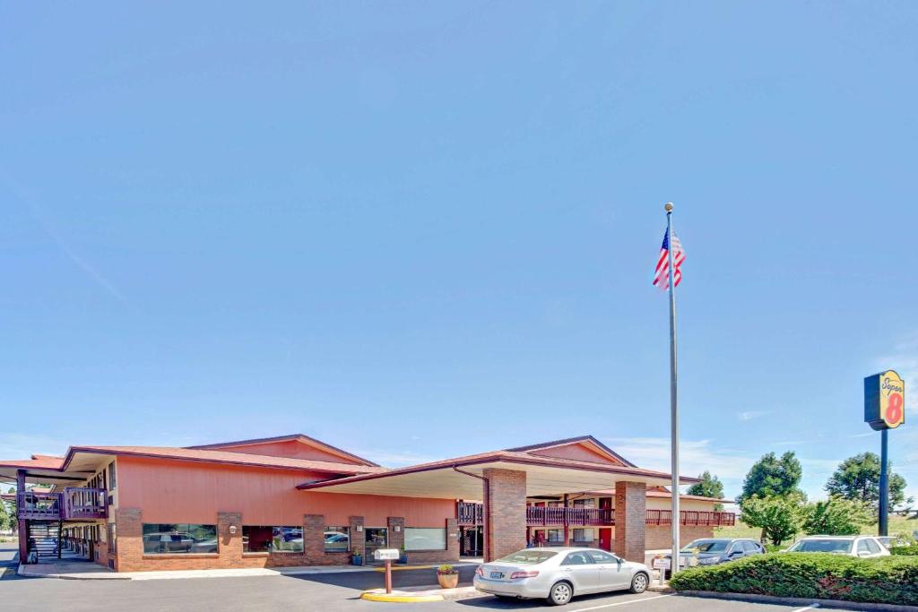 a gas station with a car parked in a parking lot at Super 8 by Wyndham Albany in Albany