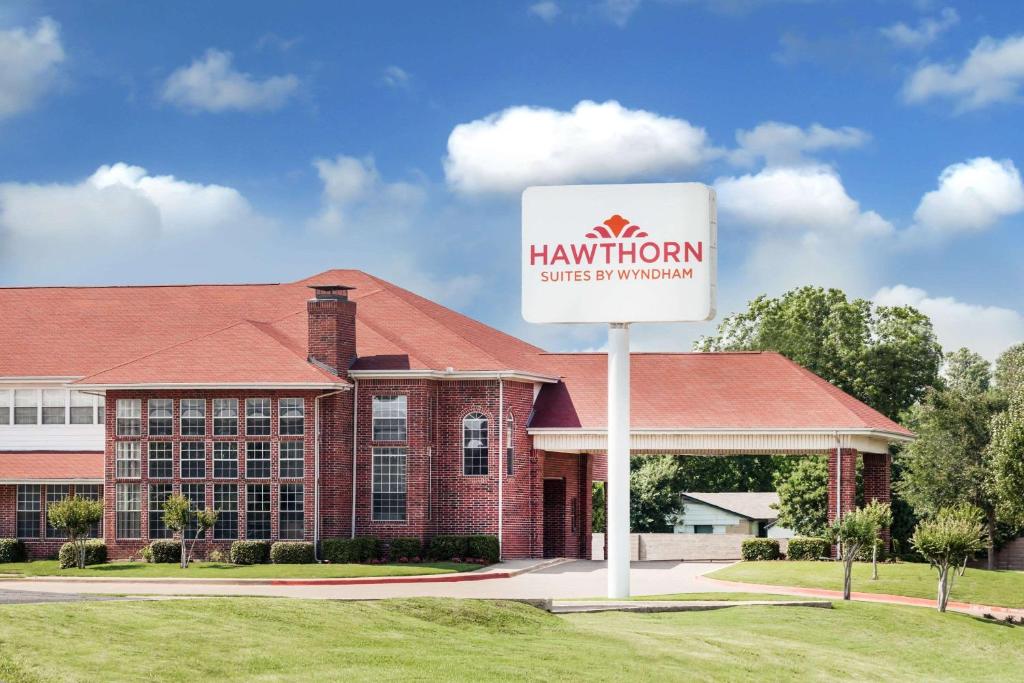 a hampton sign in front of a building at Hawthorn Suites Irving DFW South in Irving