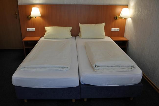 Postel nebo postele na pokoji v ubytování Hotel Bürgerhof