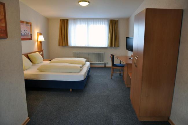 Postel nebo postele na pokoji v ubytování Hotel Bürgerhof