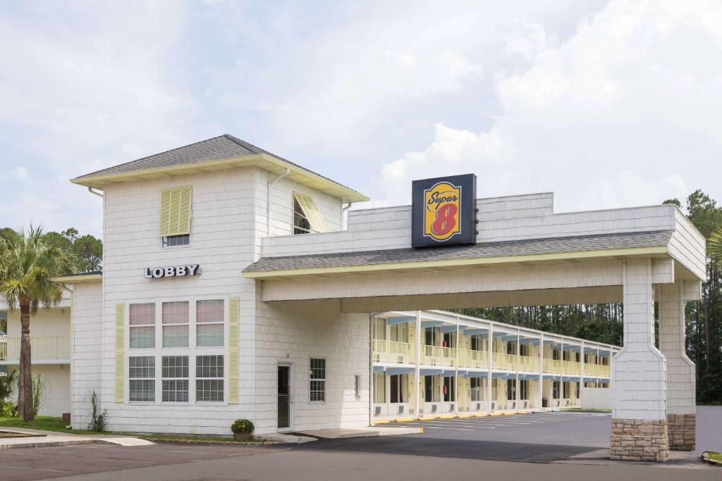 a building with a sign on top of it at Super 8 By Wyndham Kingsland I-95 Naval Base Area in Kingsland