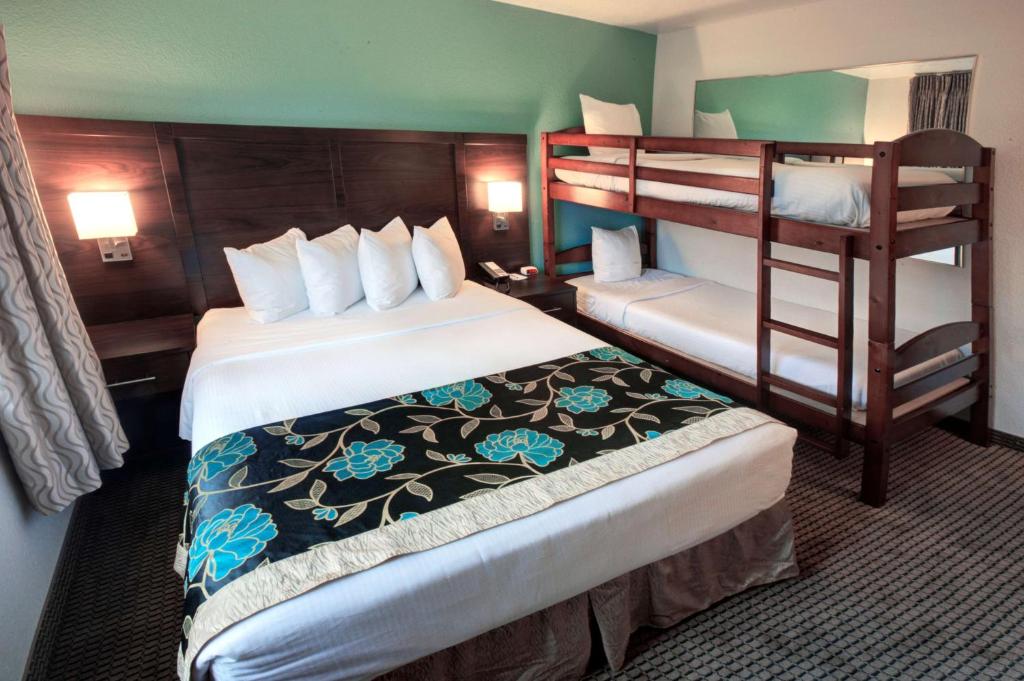 a hotel room with two beds and a bunk bed at Baymont by Wyndham Keystone Near Mt. Rushmore in Keystone