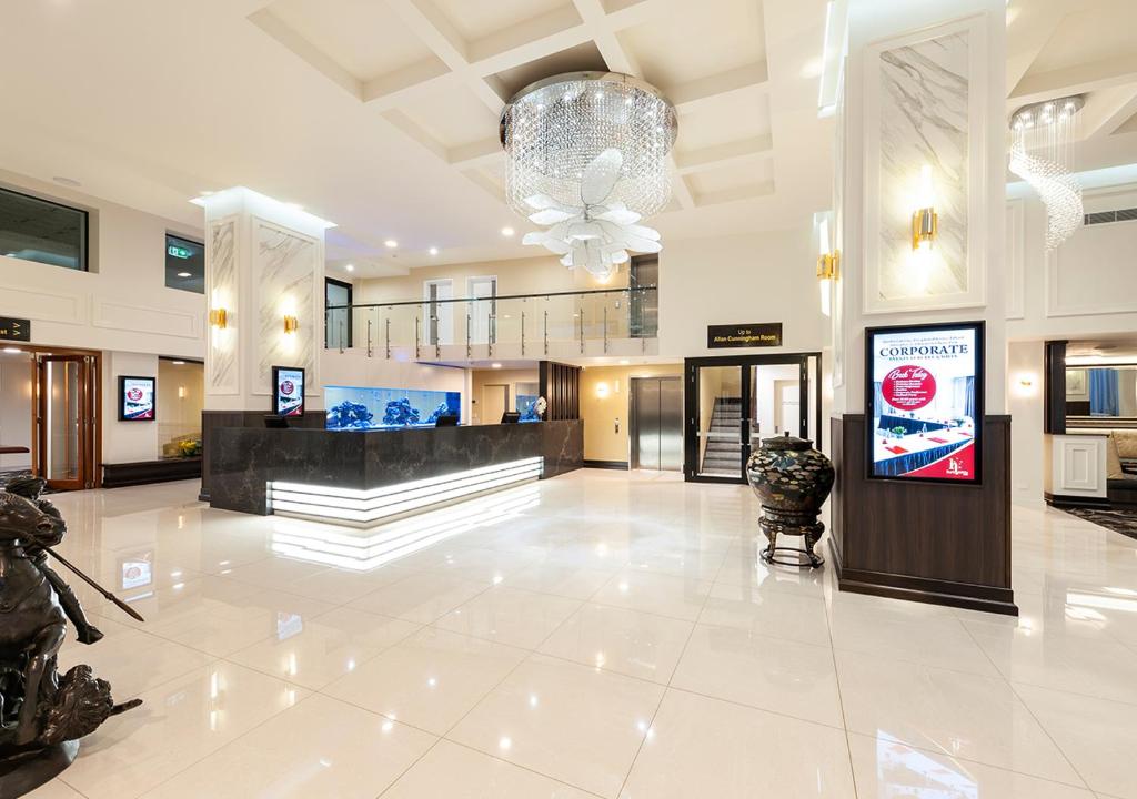 a lobby of a building with a chandelier at Burke and Wills Hotel Toowoomba in Toowoomba